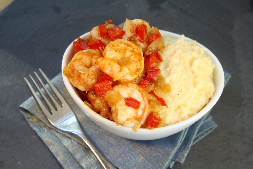 Make Shrimp & Grits! Shrimp & Grits are a southern staple. Originating from the Carolina low country, they are a classic dish served for breakfast or dinner. Folklore has it that Shrimp & Grits got its start as the breakfast of fishermen who tossed sauteed shrimp onto a bed of grits.  My version also includes diced onion, red bell pepper and garlic served atop the cheesiest grits ever.