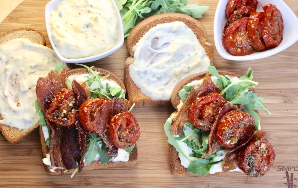 Learn how to Roast Tomatoes and make this BLT with Roasted Tomatoes. This is NOT your run of the mill BLT. I’ve taken the standard ingredients (bacon, lettuce and tomato) and turned them up about a thousand notches. Bacon, well the bacon remains untouched because there’s no improving perfection. Boring iceberg or romaine lettuce is replaced with peppery arugula, mayo with my fantastic Garlic Herb Mayo and the role of tomato is now being played by those roasted tomatoes I’ve been going on about. All of these combine to create a delicious symphony of flavor and texture that’s almost too much for a humble sandwich. 