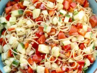 Spaghetti in a bowl with Chopped tomatoes and cucumbers
