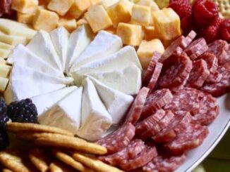 Assorted cheese, fruit, crackers, dips and meats on a platter